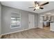 Open-concept living area with modern wood floors and neutral gray walls, view of window and door at 7101 Kingston Dr, Tampa, FL 33619
