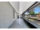 View of a covered screened in porch with white ceiling and support beams at 7101 Kingston Dr, Tampa, FL 33619