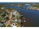 Waterfront home features a private dock, and a sparkling pool with views of the surrounding waterways and lush landscaping at 714 Bayshore Dr, Tarpon Springs, FL 34689