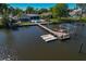 Aerial view of waterfront home with dock, boat lift, and floating jet ski platform at 714 Bayshore Dr, Tarpon Springs, FL 34689