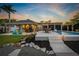 Backyard with an outdoor kitchen under a pavilion and beautiful pool area for entertainment and relaxation at 714 Bayshore Dr, Tarpon Springs, FL 34689
