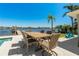 Backyard patio featuring an outdoor dining table and a view of the waterfront and boat dock at 714 Bayshore Dr, Tarpon Springs, FL 34689