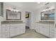 Elegant bathroom with dual vanities, decorative mirrors, and modern fixtures at 714 Bayshore Dr, Tarpon Springs, FL 34689