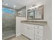 Well-lit bathroom showcasing a glass shower and vanity with decorative mirror at 714 Bayshore Dr, Tarpon Springs, FL 34689