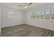 Bright bedroom featuring white shutters, neutral walls, and hardwood floors creating a serene atmosphere at 714 Bayshore Dr, Tarpon Springs, FL 34689