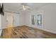 Bright bedroom featuring wood floors, modern ceiling fan, access to the patio through white framed double doors, and a barn door at 714 Bayshore Dr, Tarpon Springs, FL 34689
