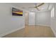 Bright bedroom featuring light wood floors, a ceiling fan, and a wall-mounted television for ultimate comfort at 714 Bayshore Dr, Tarpon Springs, FL 34689