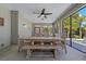Screened in patio with dining table and ceiling fan overlooking the pool and beautiful landscape at 714 Bayshore Dr, Tarpon Springs, FL 34689