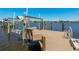 Waterfront dock featuring boat lift and seating area with river views at 714 Bayshore Dr, Tarpon Springs, FL 34689