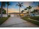 Charming single-story home with lush landscaping, mature palms, and paved driveway at 714 Bayshore Dr, Tarpon Springs, FL 34689