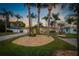 Well-manicured front yard showcasing lush landscaping, mature palm trees, and an inviting entrance with a cozy home at 714 Bayshore Dr, Tarpon Springs, FL 34689