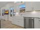 Bright kitchen with a farmhouse sink, stainless steel dishwasher, and ample cabinet space at 714 Bayshore Dr, Tarpon Springs, FL 34689