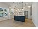 Updated kitchen with blue island, stainless steel appliances, and white cabinets at 714 Bayshore Dr, Tarpon Springs, FL 34689