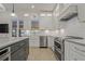 Well-lit kitchen with stainless steel appliances, white cabinets, and marble countertops at 714 Bayshore Dr, Tarpon Springs, FL 34689