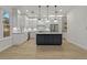Bright, modern kitchen with white cabinetry, stainless steel appliances, and an island with dark countertops at 714 Bayshore Dr, Tarpon Springs, FL 34689