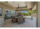 Covered outdoor patio with a dining table, ceiling fan, and recessed lighting, great for entertaining at 714 Bayshore Dr, Tarpon Springs, FL 34689