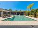 Sparkling pool surrounded by a well-maintained deck and lush landscaping at 714 Bayshore Dr, Tarpon Springs, FL 34689