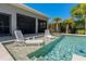 Relaxing sun shelf area in the pool with lounge chairs and water features for the ultimate backyard experience at 714 Bayshore Dr, Tarpon Springs, FL 34689