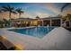 Beautiful pool at dusk with outdoor dining and lounge areas at 714 Bayshore Dr, Tarpon Springs, FL 34689