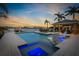 Luxury waterfront home featuring a pool, spa, and outdoor living area perfect for enjoying the water view at 714 Bayshore Dr, Tarpon Springs, FL 34689