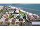 Aerial view of beachside condos showcasing the pool, beach access, and lush landscaping at 895 S Gulfview Blvd # 309, Clearwater Beach, FL 33767