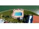 Aerial view featuring a pool deck with lounge chairs and a pool on a waterfront lawn at 895 S Gulfview Blvd # 309, Clearwater Beach, FL 33767
