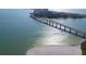 Scenic aerial view featuring a bridge leading to beachfront condos, with clear waters surrounding at 895 S Gulfview Blvd # 309, Clearwater Beach, FL 33767