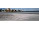 Expansive beach leading to waterfront homes, showcasing the coastal lifestyle of this community at 895 S Gulfview Blvd # 309, Clearwater Beach, FL 33767