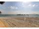 Scenic beach with tranquil waters, palm trees, and views of the city skyline in the distance at 895 S Gulfview Blvd # 309, Clearwater Beach, FL 33767