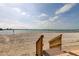 Beautiful beach with wooden stairs leading down to the sandy shore and tranquil ocean waters at 895 S Gulfview Blvd # 309, Clearwater Beach, FL 33767