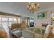 Dining room with chandelier, glass table, and water view at 895 S Gulfview Blvd # 309, Clearwater Beach, FL 33767