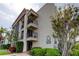 Condo building with beautiful landscaping, brick pavers, and private balconies at 895 S Gulfview Blvd # 309, Clearwater Beach, FL 33767