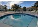 Relaxing community hot tub surrounded by comfortable lounge chairs, umbrellas, palm trees, and picturesque water views at 895 S Gulfview Blvd # 309, Clearwater Beach, FL 33767