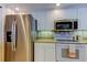 This kitchen features stainless steel appliances, white cabinets, and ample countertop space at 895 S Gulfview Blvd # 309, Clearwater Beach, FL 33767