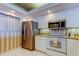 Modern kitchen featuring stainless steel appliances, neutral countertops, and classic cabinetry at 895 S Gulfview Blvd # 309, Clearwater Beach, FL 33767