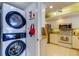 A modern laundry room near the kitchen, complete with stacked washer and dryer at 895 S Gulfview Blvd # 309, Clearwater Beach, FL 33767