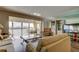 Bright living room with water views, comfortable seating, and entertainment center at 895 S Gulfview Blvd # 309, Clearwater Beach, FL 33767