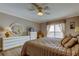 A main bedroom with hardwood floors, soft lighting, and balcony at 895 S Gulfview Blvd # 309, Clearwater Beach, FL 33767