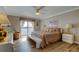 A main bedroom with hardwood floors, soft lighting, and balcony at 895 S Gulfview Blvd # 309, Clearwater Beach, FL 33767