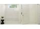 Bright bathroom featuring a spacious white tiled shower with bench and clear glass door at 9340 Gladsome Dr, Land O Lakes, FL 34637