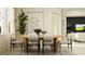 Bright dining room featuring a table for four, modern decor and an open layout at 9340 Gladsome Dr, Land O Lakes, FL 34637