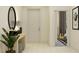 Inviting foyer with a mirror, plant and view into a bedroom with guitar at 9340 Gladsome Dr, Land O Lakes, FL 34637