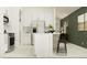 Modern kitchen featuring white cabinets, stainless steel appliances, and a stylish breakfast bar with seating at 9425 Raised Tulip Ln, Land O Lakes, FL 34637