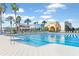 Community pool with sun loungers and palm trees at the Fit & Flourish facility, perfect for relaxation and recreation at 9425 Raised Tulip Ln, Land O Lakes, FL 34637