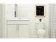 Clean, bright bathroom with white vanity, toilet, and minimalist decor at 9475 Raised Tulip Ln, Land O Lakes, FL 34637