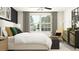 Bright bedroom with a large window, comfy king bed, and contemporary decor at 9475 Raised Tulip Ln, Land O Lakes, FL 34637