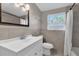 Bathroom showcasing tiled walls, shower with curtain and sleek vanity at 10426 109Th St, Seminole, FL 33778