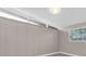 Bedroom with wood paneling, neutral walls, and natural light at 10426 109Th St, Seminole, FL 33778