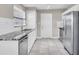 Kitchen featuring white cabinets, granite countertops, stainless steel appliances, and tile floors at 10426 109Th St, Seminole, FL 33778