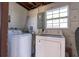Functional laundry room includes a washer, dryer, and natural light from a window at 10426 109Th St, Seminole, FL 33778